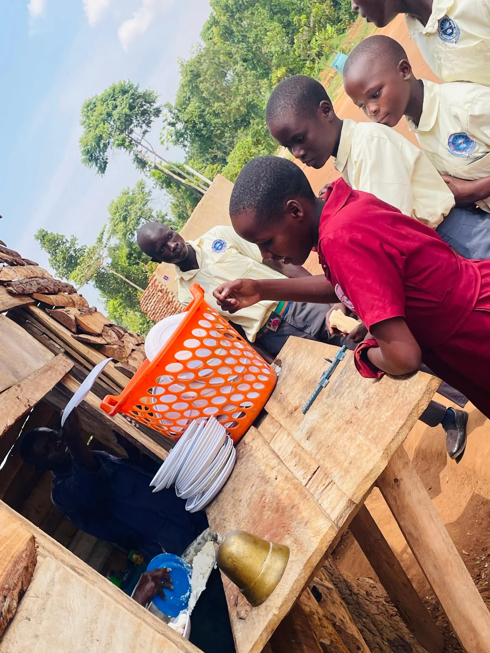 Students queue at a wooden service hatch at break time